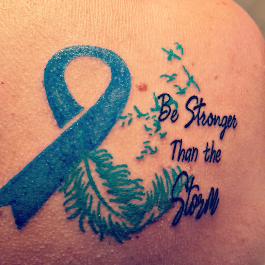 An image of Hayley's tattoo which says 'Be stronger than the storm' (referring to IIH).